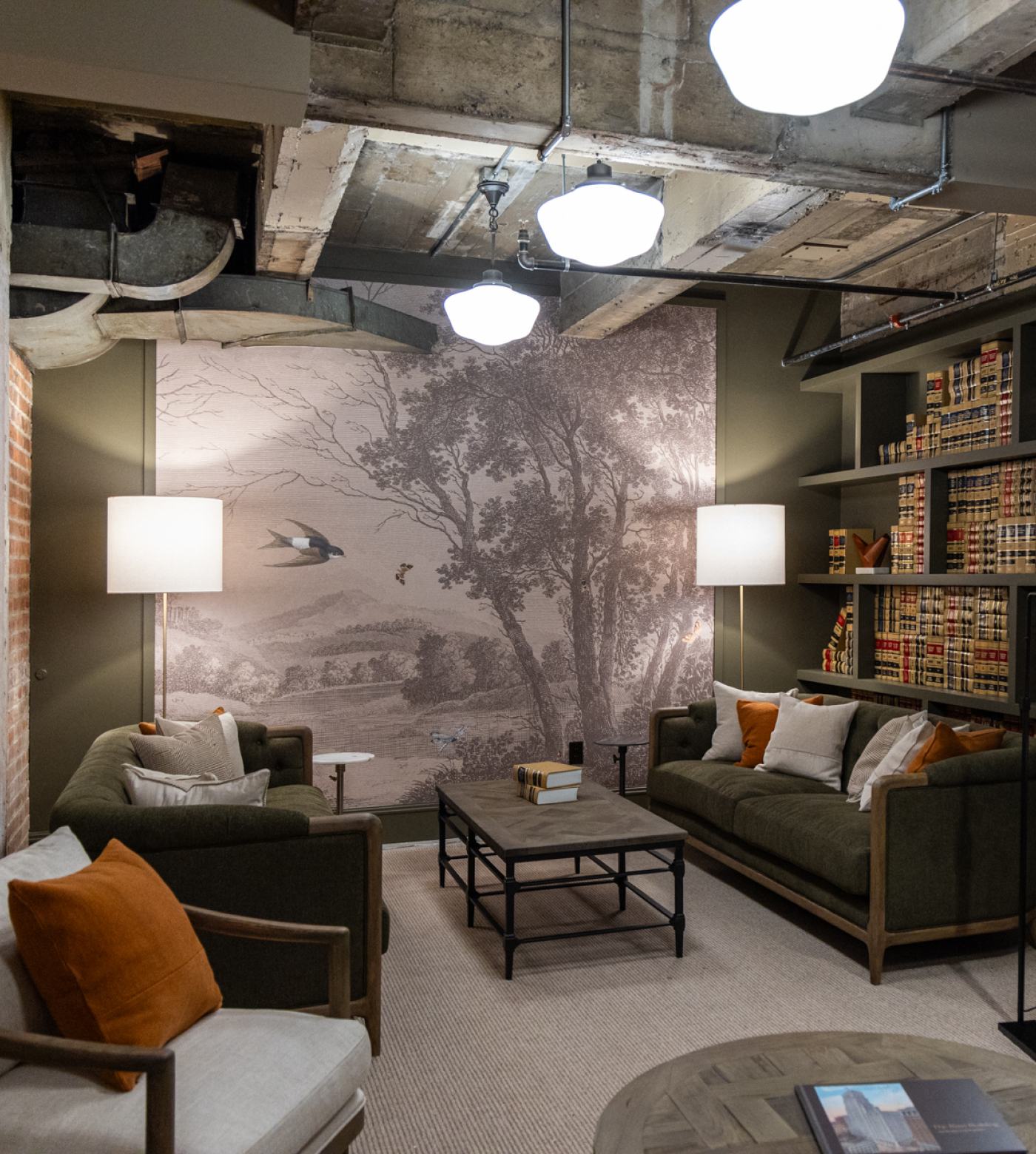 View of lobby lounge back wall with couches, coffee table, and bookshelf